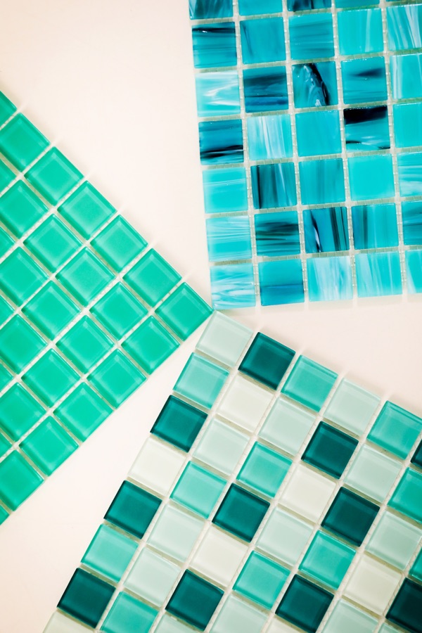 Faixa de pastilhas em tons de azul em piscina de fibra